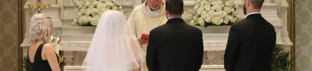 a couple in front of a priest during wedding ceremony