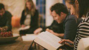 small group of people reading bible
