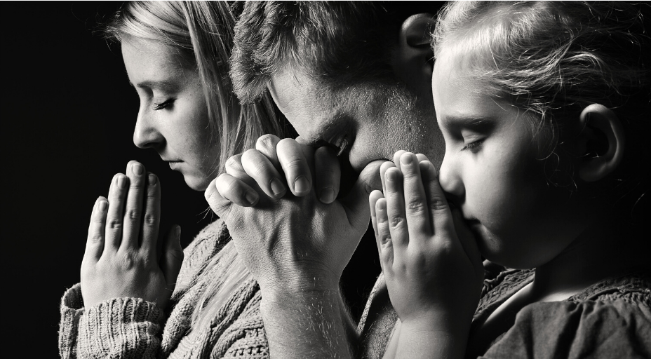 family praying together