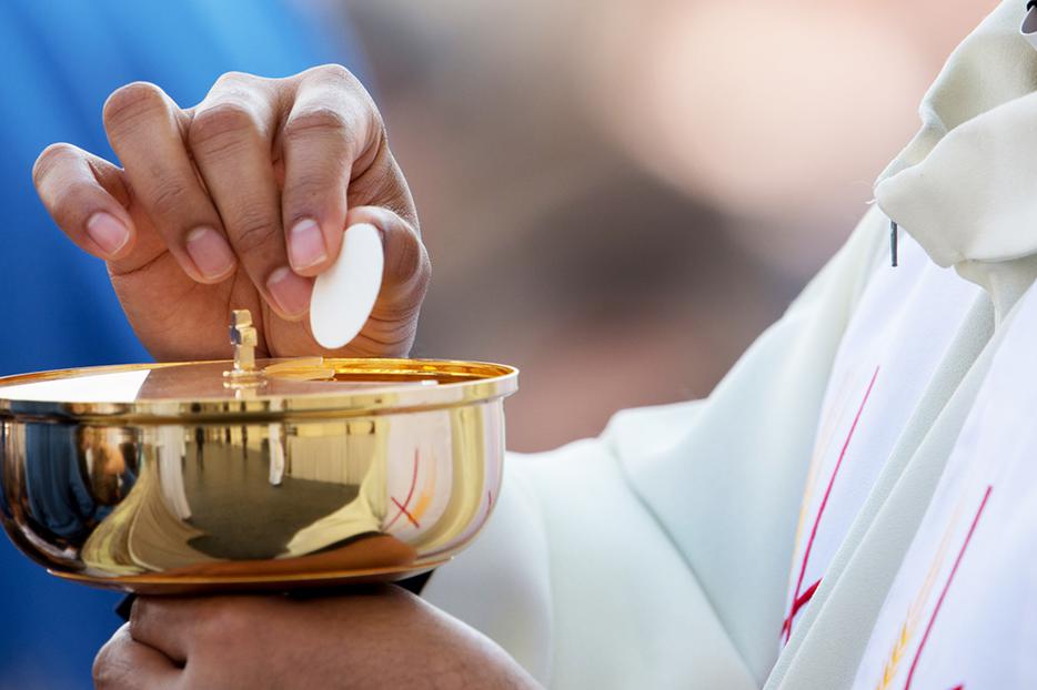 Priest holding a host